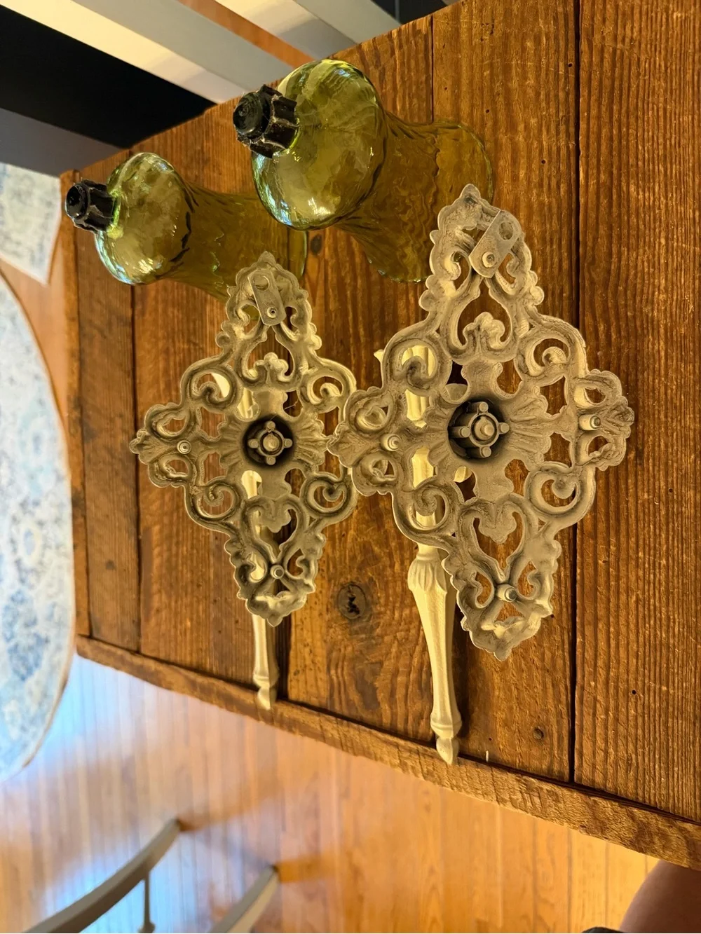 (2) vintage cast metal candle wall sconces paired with green glass votive cups